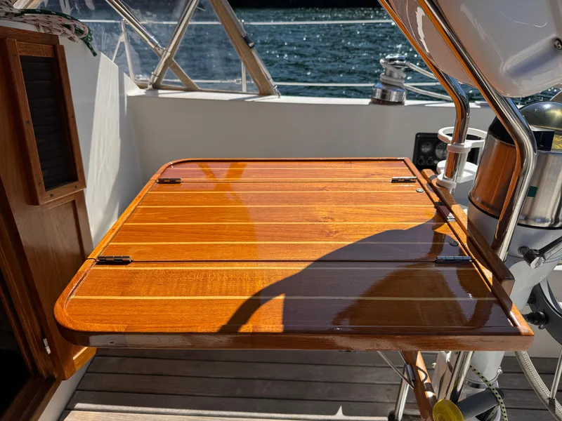 Slide: The Image of Polished wooden table on 1989 Nonsuch 30 Ultra sailboat deck, with ocean view. - 41