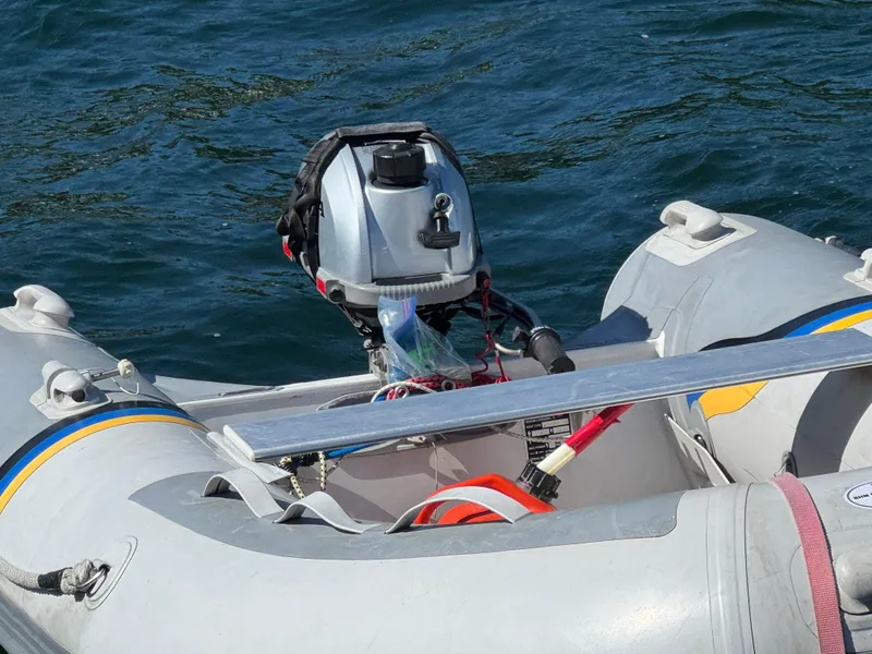 Slide: The Image of Inflatable boat with outboard motor on water, Nonsuch 30 Ultra, 1989 model. - 44