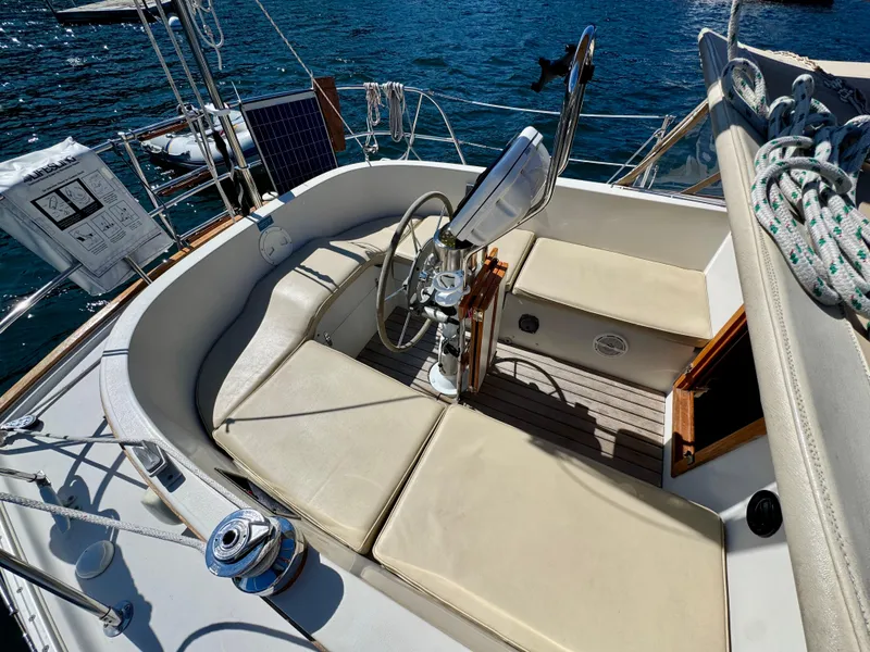 Slide: The Image of Cockpit of 1989 Nonsuch 30 Ultra sailboat with cushioned seating and steering wheel. - 45