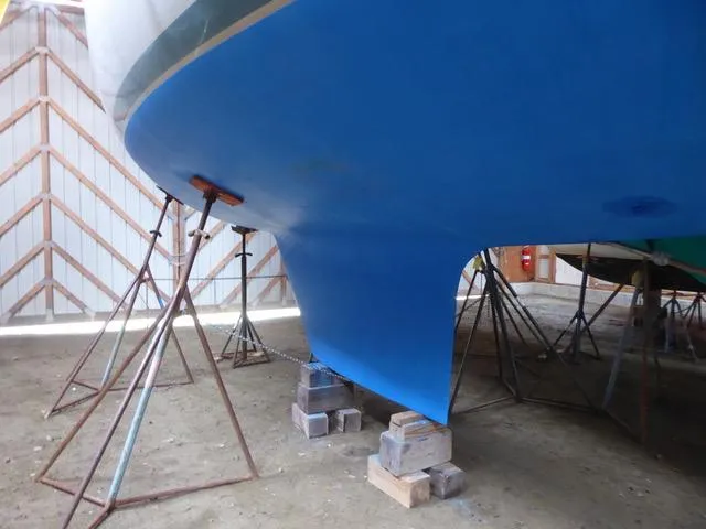 Slide: The Image of 1989 Nonsuch 30 Ultra sailboat hull on stands in a boatyard. - 8