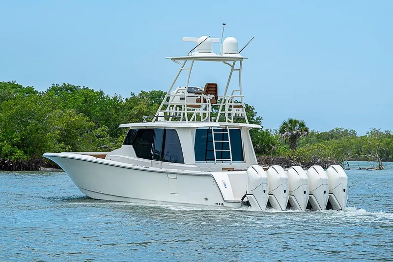 The Image of 2021 Gulf Crosser 52 boat cruising on water with lush greenery in background. - 0