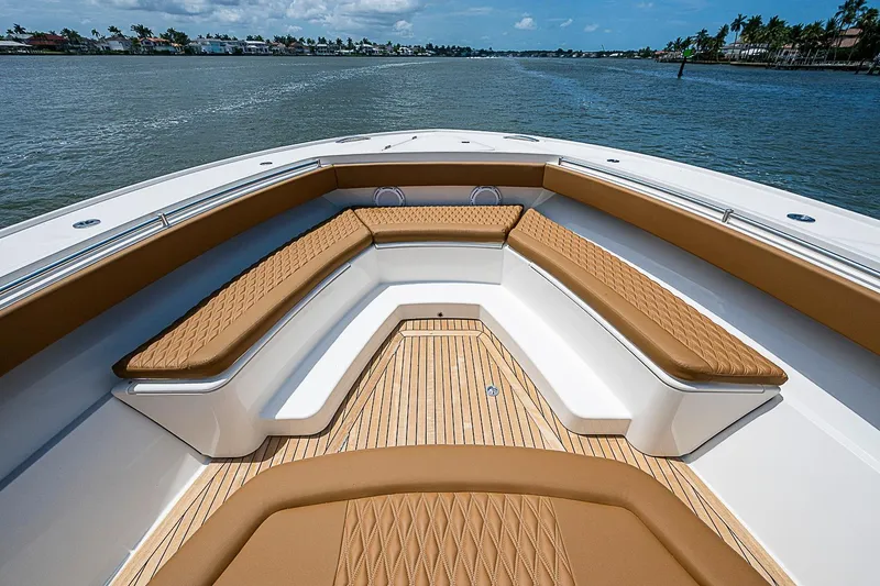 Slide: The Image of Luxurious seating on 2021 Gulf Crosser 52 yacht, featuring elegant tan upholstery and wood decking. - 100