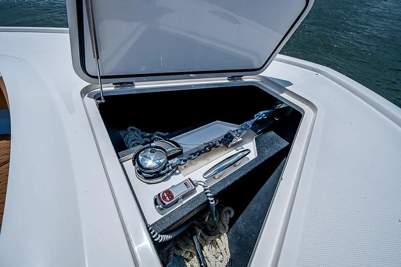 Slide: The Image of Open anchor compartment on 2021 Gulf Crosser 52 yacht, featuring chain and control panel. - 101