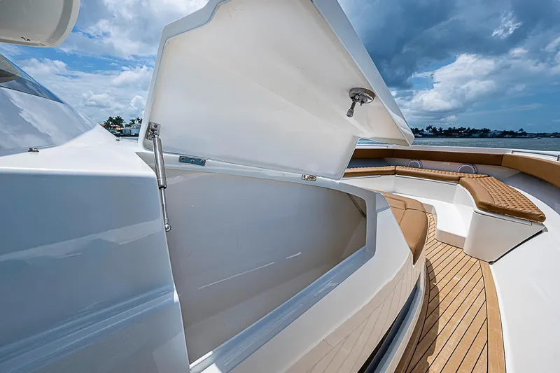 Slide: The Image of 2021 Gulf Crosser 52 yacht with open storage compartment and luxurious seating. - 11