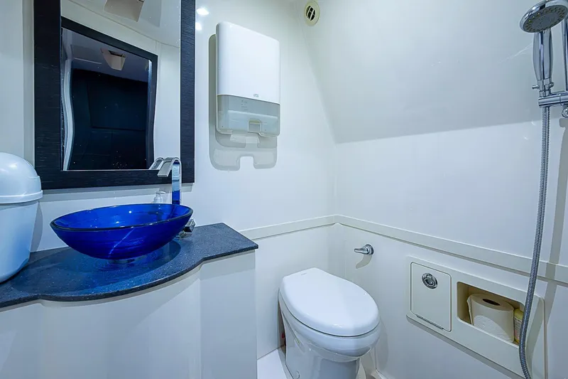 Slide: The Image of Luxurious bathroom in 2021 Gulf Crosser 52 yacht with blue glass sink and modern fixtures. - 18