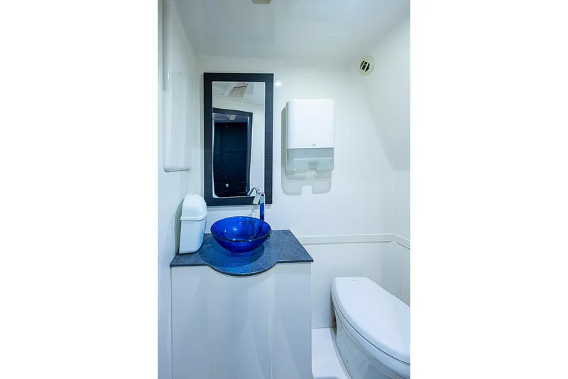 Slide: The Image of Luxurious bathroom in 2021 Gulf Crosser 52 yacht with blue glass sink and modern fixtures. - 19