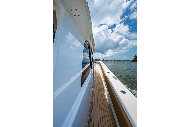 Slide: The Image of 2021 Gulf Crosser 52 yacht cruising on a sunny day with blue skies. - 2