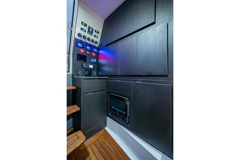 Slide: The Image of Control panel and cabinetry inside 2021 Gulf Crosser 52 yacht, featuring modern design and wood flooring. - 21