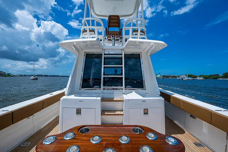 Slide: The Image of Gulf Crosser 52 yacht, 2021 model, featuring a sleek deck and luxurious seating on open water. - 22