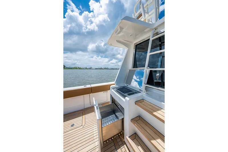 Slide: The Image of Luxurious 2021 Gulf Crosser 52 yacht deck with sleek design and scenic water view. - 28