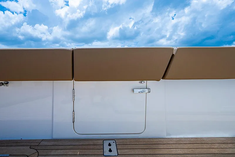 Slide: The Image of Gulf Crosser 52 yacht deck with tan cushions and blue sky, 2021 model. - 29
