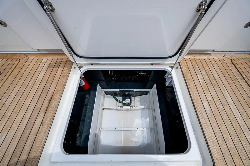 Slide: The Image of Open hatch on 2021 Gulf Crosser 52 boat deck, revealing storage compartment. - 30