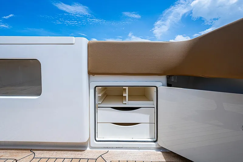 Slide: The Image of Storage compartment on 2021 Gulf Crosser 52 yacht, featuring drawers and shelves under a blue sky. - 33