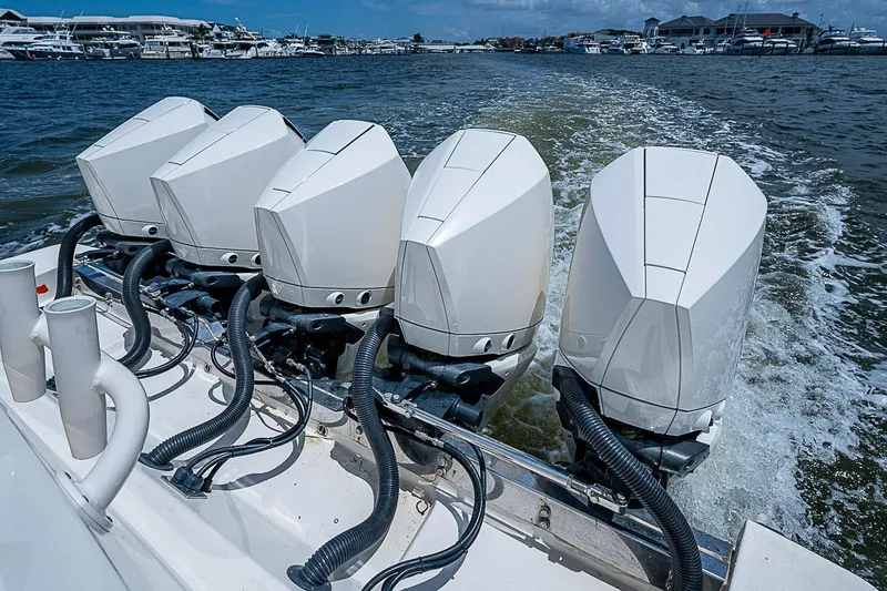 Slide: The Image of Five powerful outboard motors on a 2021 Gulf Crosser 52 boat cruising in a marina. - 35