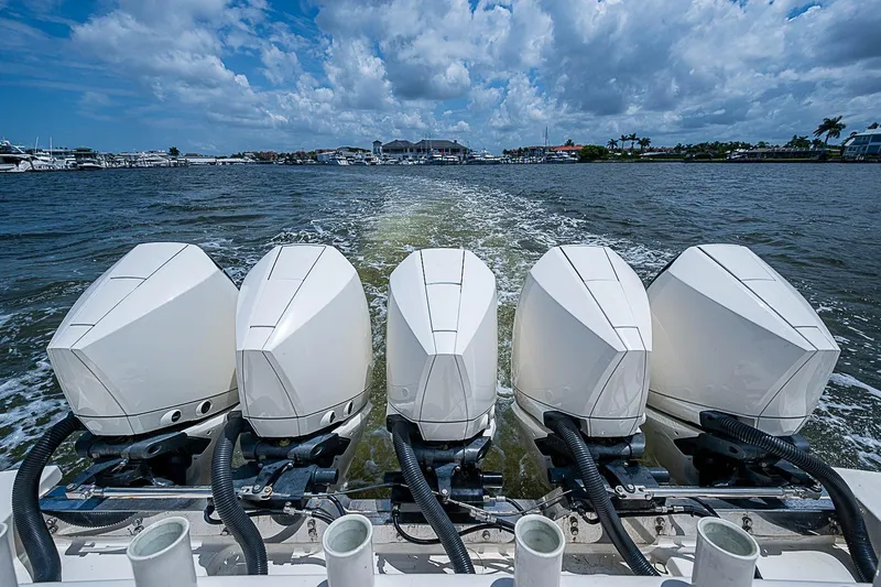 Slide: The Image of Five powerful outboard engines on a 2021 Gulf Crosser 52 boat, cruising through open water. - 36