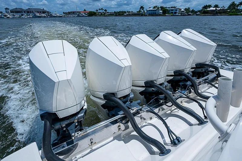 Slide: The Image of Five powerful outboard motors on a 2021 Gulf Crosser 52 boat cruising on water. - 37