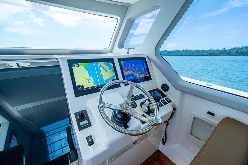 Slide: The Image of Cockpit of 2021 Gulf Crosser 52 yacht with navigation screens and steering wheel. - 39