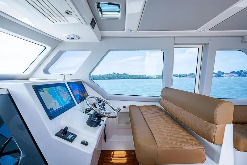 Slide: The Image of Interior of 2021 Gulf Crosser 52 yacht with modern helm and leather seating. - 40