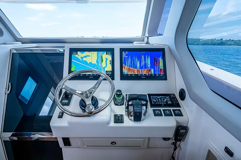 Slide: The Image of Cockpit of 2021 Gulf Crosser 52 yacht with navigation screens and steering wheel. - 43