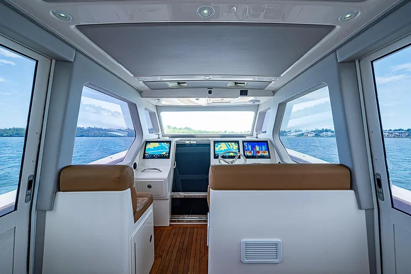 Slide: The Image of Interior view of 2021 Gulf Crosser 52 yacht cockpit with navigation screens and ocean view. - 44
