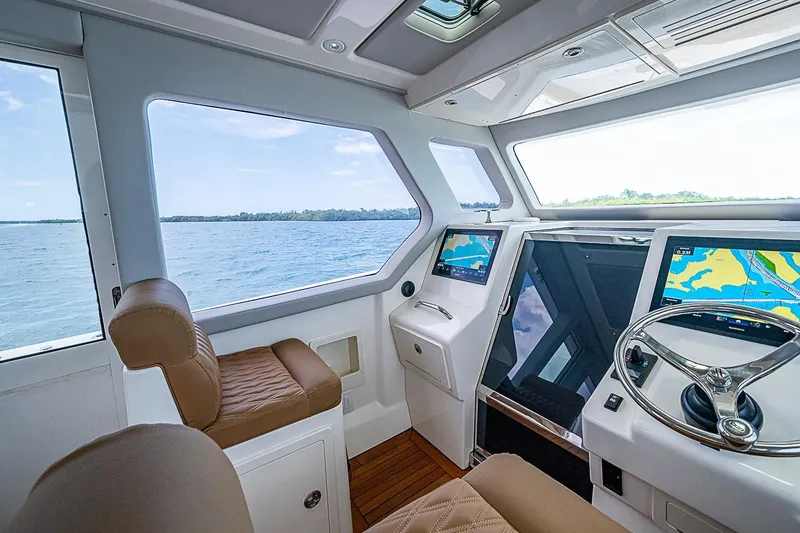 Slide: The Image of Interior view of 2021 Gulf Crosser 52 yacht cockpit with navigation screens and leather seating. - 46