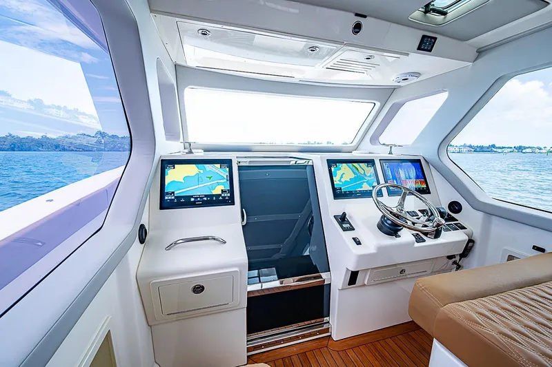 Slide: The Image of Interior view of 2021 Gulf Crosser 52 yacht cockpit with navigation screens and steering wheel. - 47
