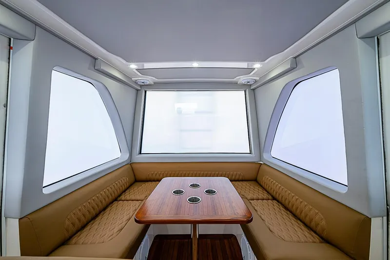 Slide: The Image of Luxurious interior of 2021 Gulf Crosser 52 yacht with elegant seating and wooden table. - 52