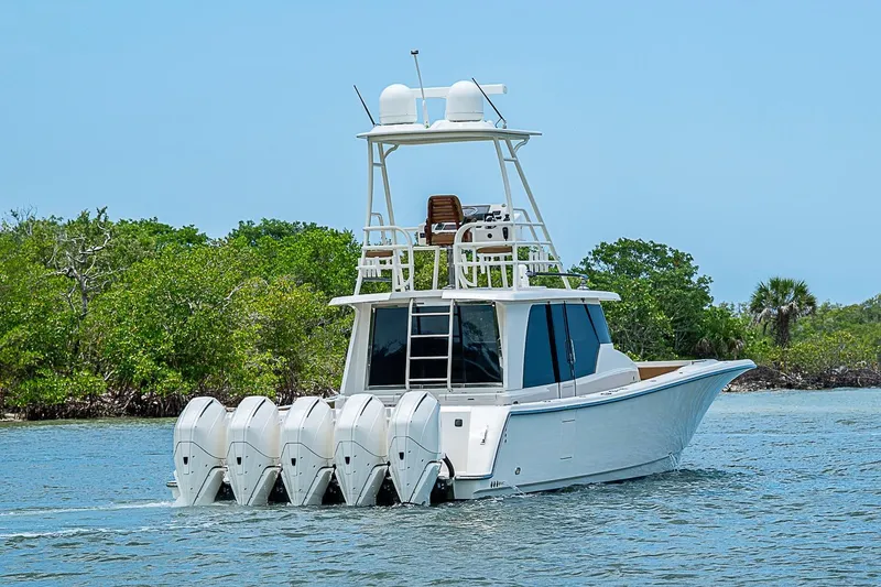 Slide: The Image of 2021 Gulf Crosser 52 yacht with five outboard engines cruising on a sunny day. - 56