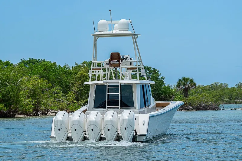 Slide: The Image of 2021 Gulf Crosser 52 yacht with multiple outboard engines cruising on a sunny day. - 57