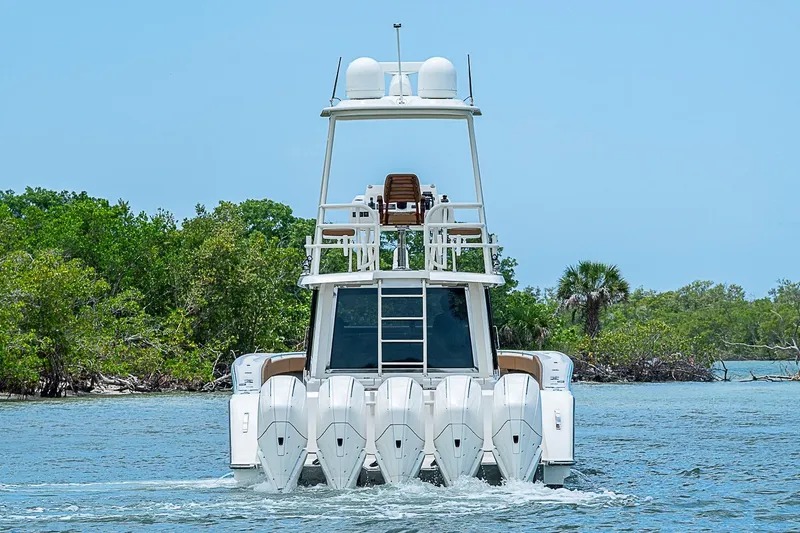 Slide: The Image of 2021 Gulf Crosser 52 yacht with multiple outboard engines cruising on a sunny day. - 58