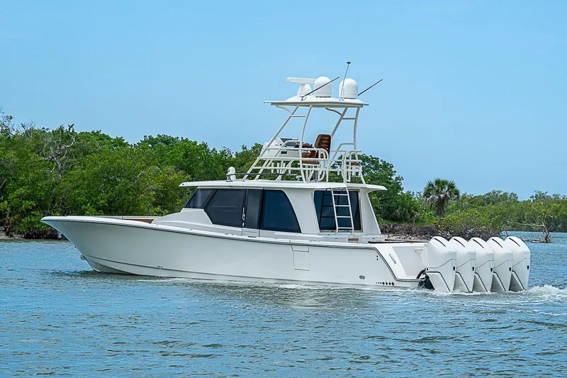 Slide: The Image of 2021 Gulf Crosser 52 boat cruising on water with multiple outboard engines. - 59