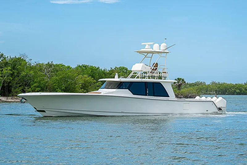 Slide: The Image of 2021 Gulf Crosser 52 yacht cruising on a serene waterway with lush greenery. - 65