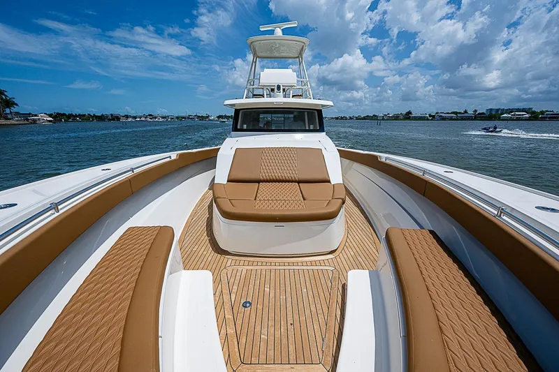 Slide: The Image of 2021 Gulf Crosser 52 yacht with luxurious seating and teak deck on a sunny day. - 7