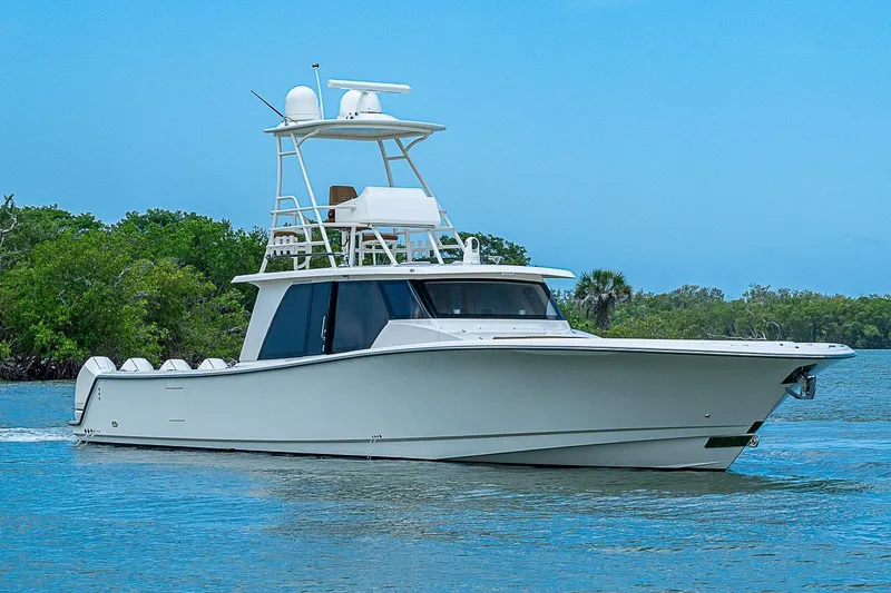 Slide: The Image of 2021 Gulf Crosser 52 yacht cruising on a serene waterway with lush greenery. - 71