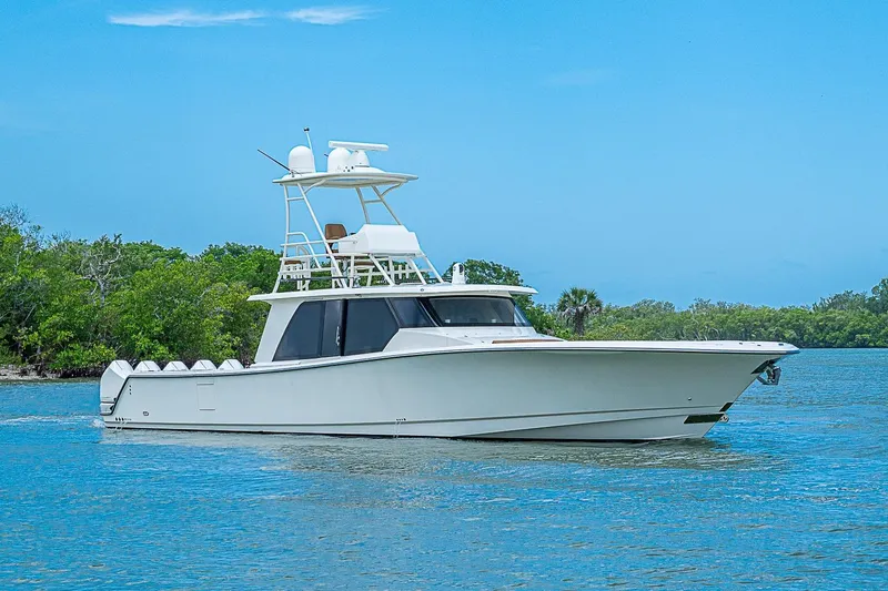 Slide: The Image of 2021 Gulf Crosser 52 yacht cruising on a serene blue waterway. - 72