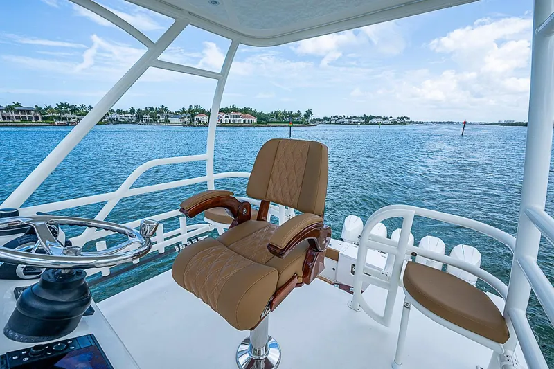 Slide: The Image of Captain's chair on 2021 Gulf Crosser 52 yacht overlooking serene waters. - 74