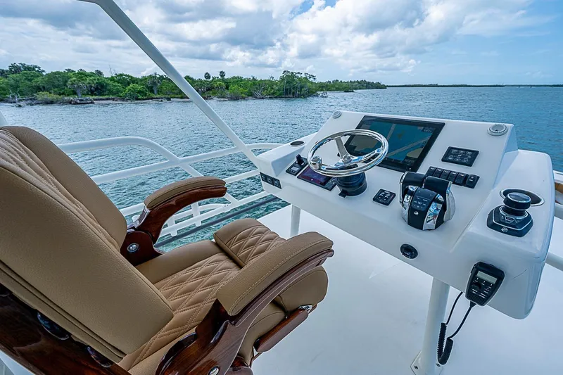 Slide: The Image of Luxurious helm of 2021 Gulf Crosser 52 yacht with leather captain's chair and advanced controls. - 76