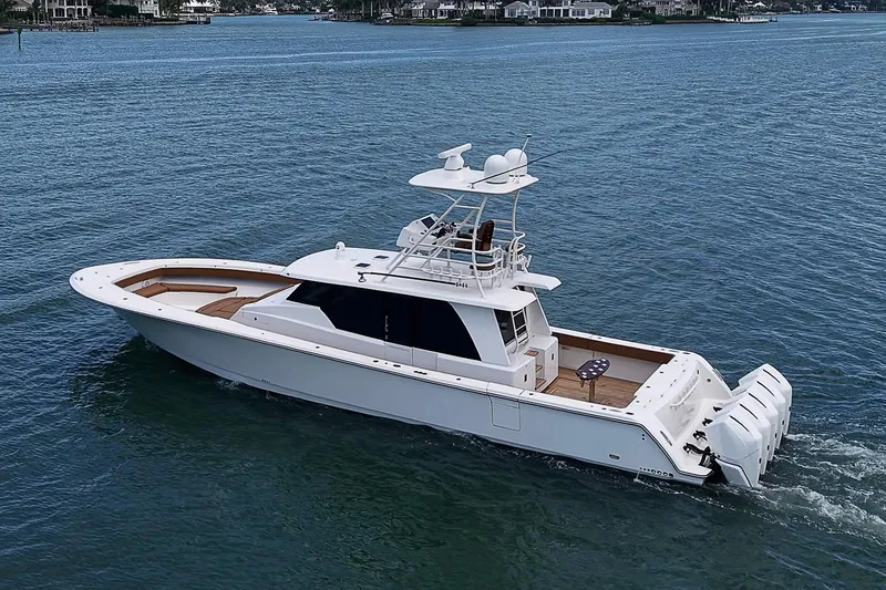 Slide: The Image of 2021 Gulf Crosser 52 yacht cruising on calm waters, showcasing sleek design and powerful engines. - 79