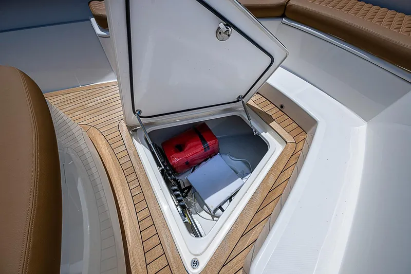 Slide: The Image of Open storage compartment on 2021 Gulf Crosser 52 boat with red equipment inside. - 8