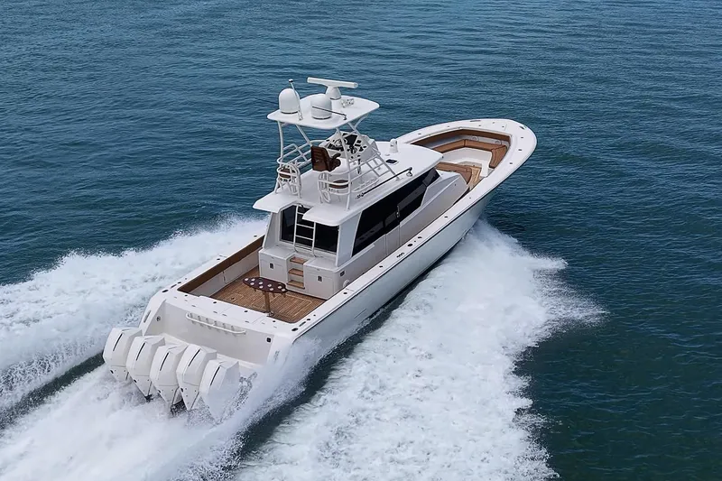 Slide: The Image of 2021 Gulf Crosser 52 yacht cruising on open water, showcasing sleek design and powerful engines. - 84