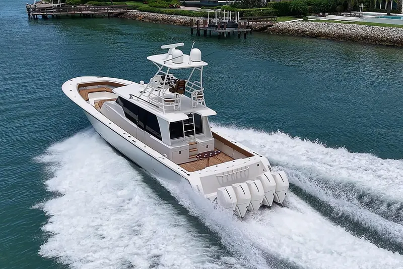 Slide: The Image of 2021 Gulf Crosser 52 yacht cruising on clear blue water, showcasing powerful engines. - 86