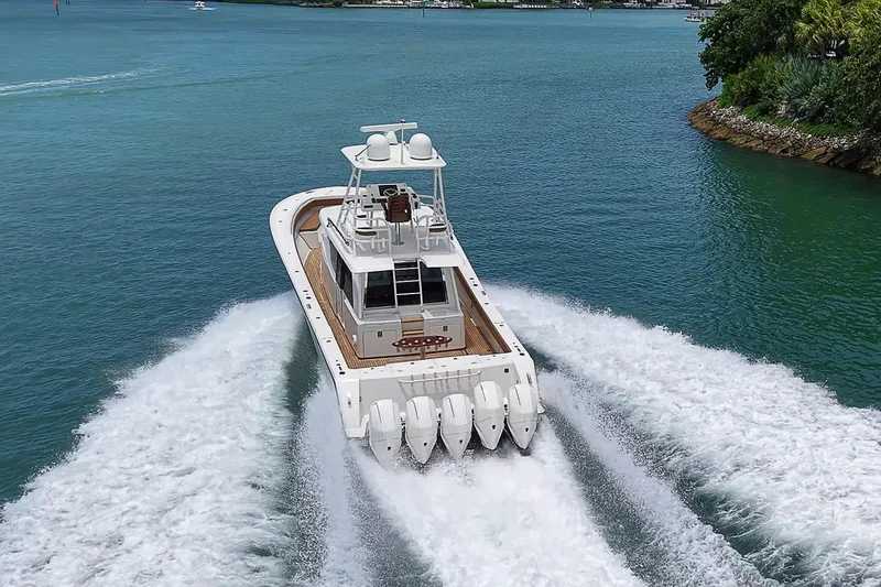 Slide: The Image of 2021 Gulf Crosser 52 yacht cruising on clear blue water, showcasing powerful engines and sleek design. - 87
