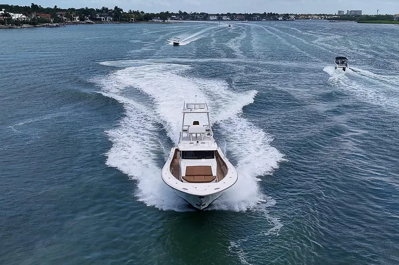 Slide: The Image of 2021 Gulf Crosser 52 yacht cruising on open water, leaving a wake behind. - 94