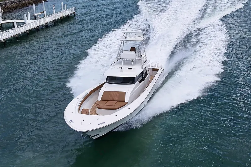 Slide: The Image of 2021 Gulf Crosser 52 yacht cruising swiftly on clear blue water. - 95