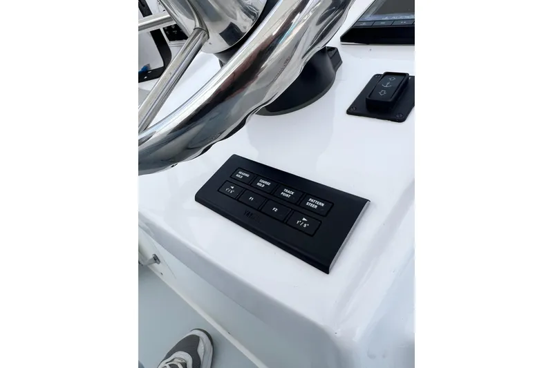 Slide: The Image of 1973 Bertram 31 Flybridge Cruiser helm with steering wheel and control panel. - 23