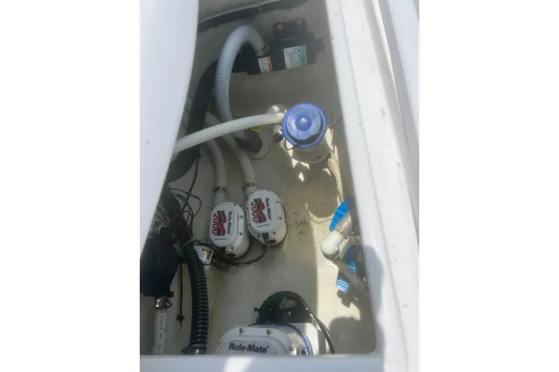 Slide: The Image of 1973 Bertram 31 Flybridge Cruiser engine compartment with Rule-Mate bilge pumps and wiring. - 18