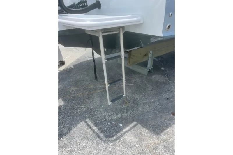 Slide: The Image of 1973 Bertram 31 Flybridge Cruiser swim ladder on concrete surface. - 25