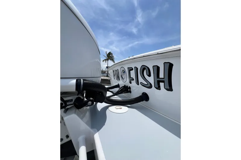 Slide: The Image of 1973 Bertram 31 Flybridge Cruiser with "Pro Fish" lettering, under a clear blue sky. - 26