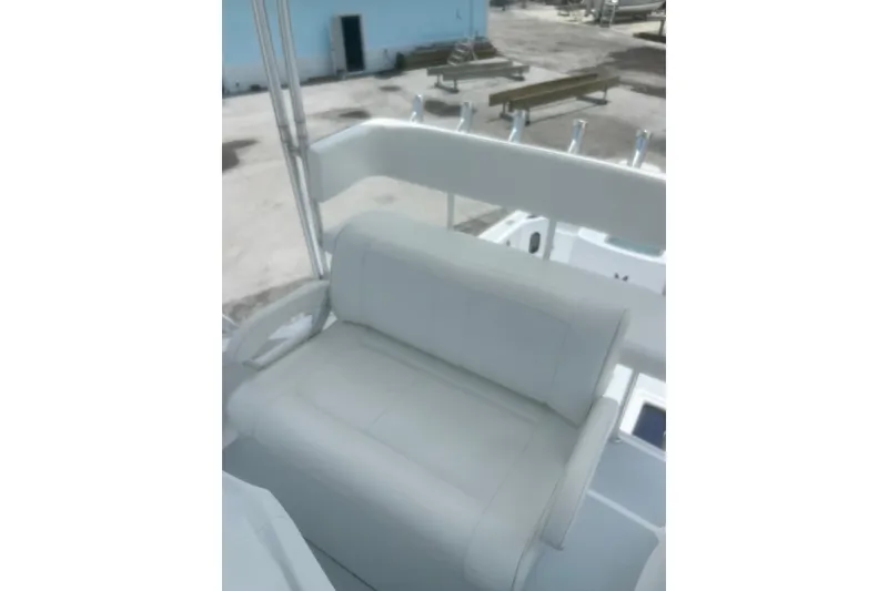 Slide: The Image of 1973 Bertram 31 Flybridge Cruiser with white seating on deck. - 20