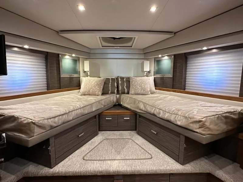 Slide: The Image of Luxurious 2019 Tiara Yachts C53 cabin with twin beds and modern decor. - 18